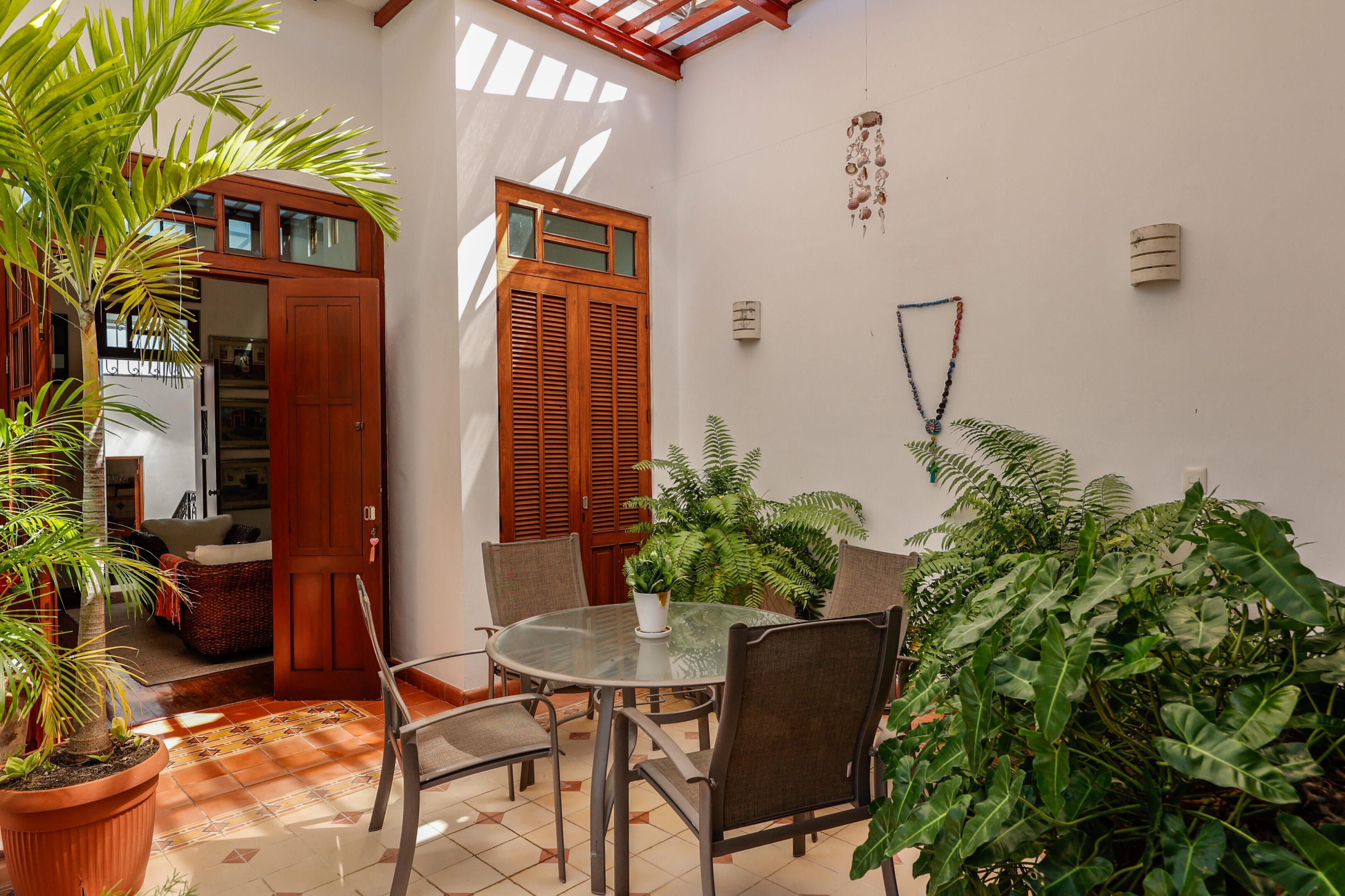 Sunlit patio with table and chairs.