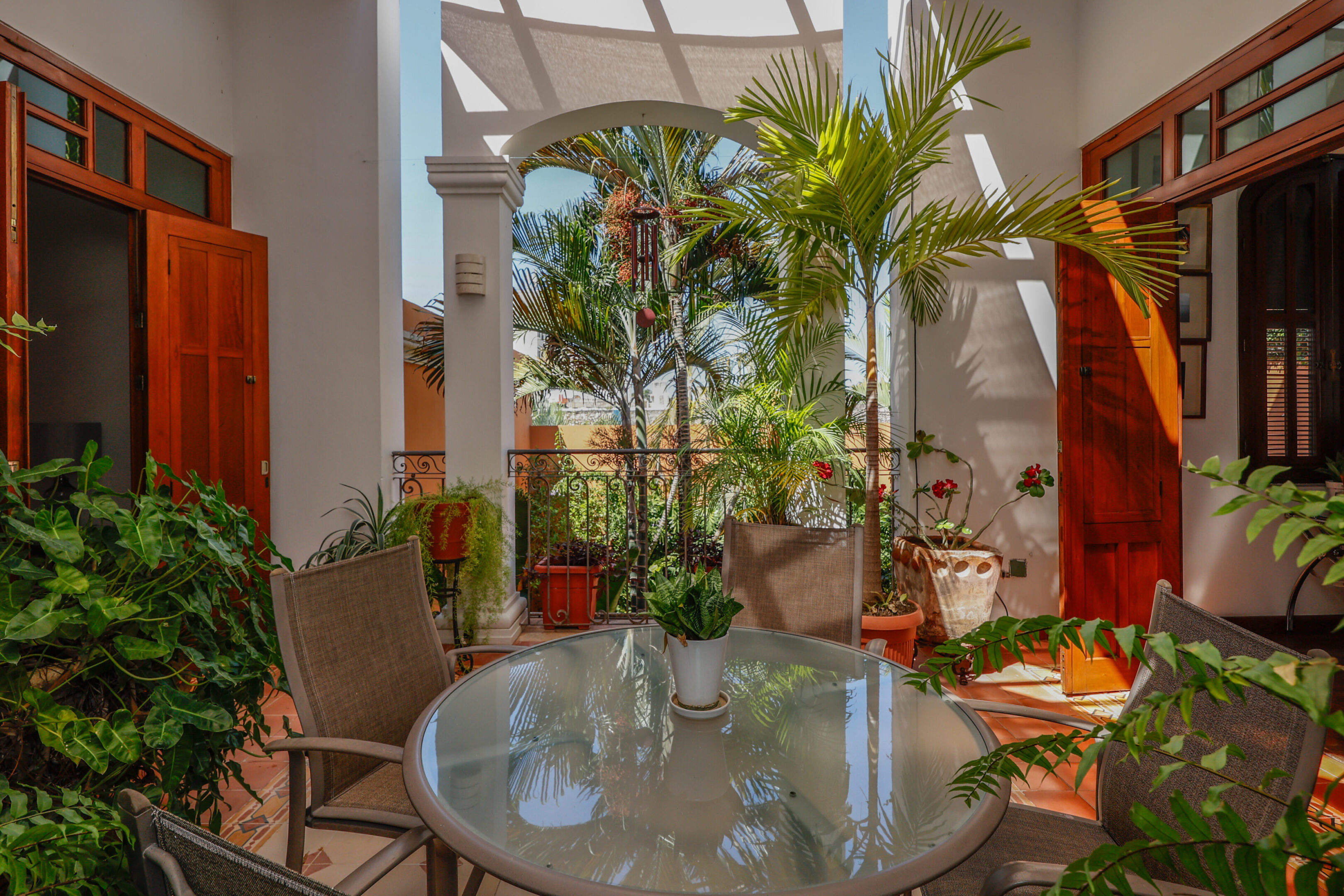 Sunlit patio with table and chairs.