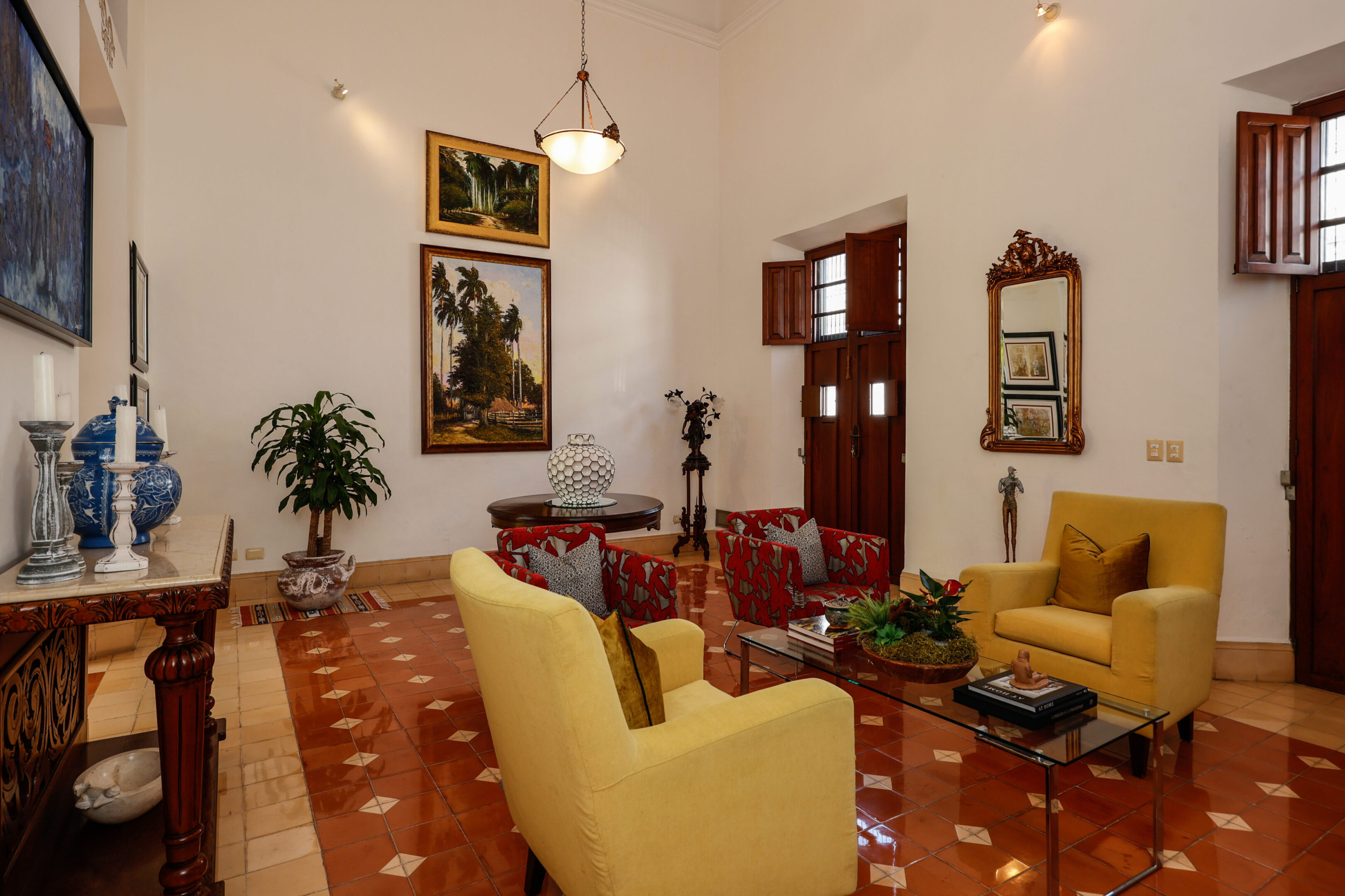 Elegant living room with yellow chairs and artwork.