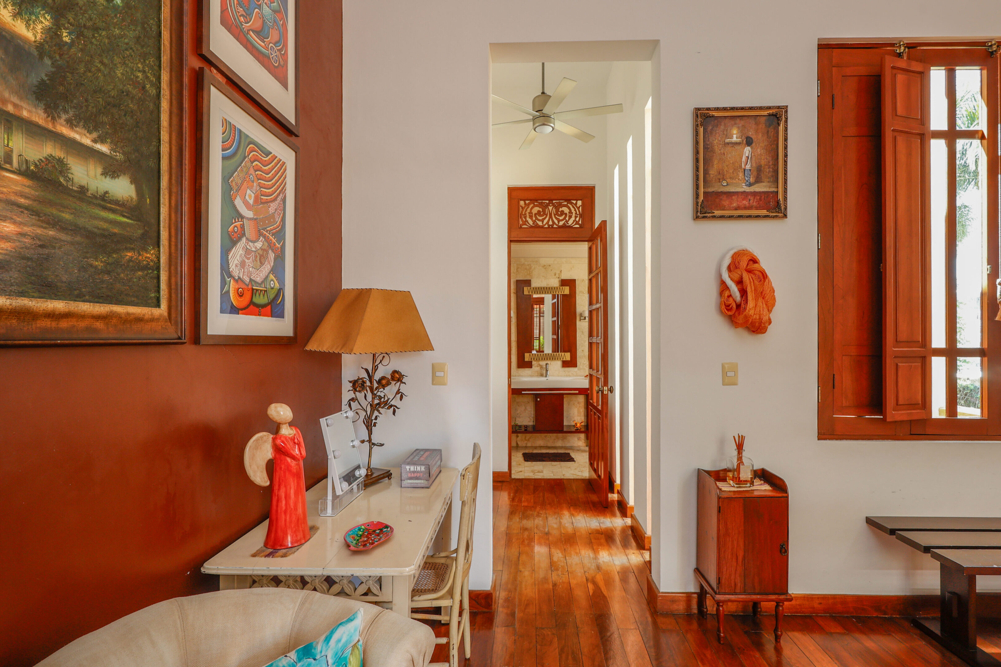 Art, desk, and hallway in a home.