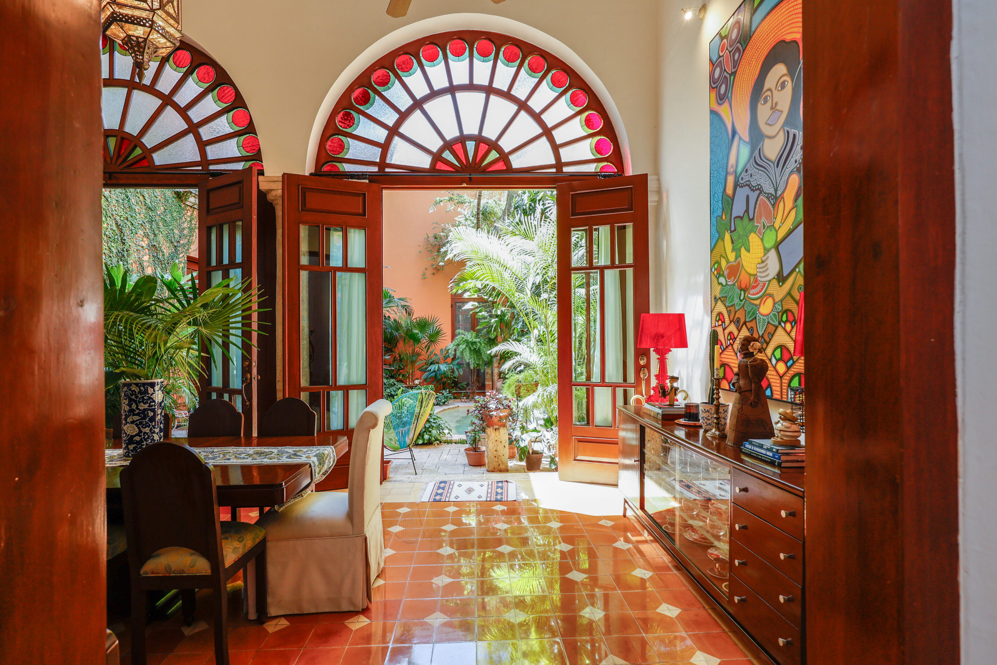 Sunlit interior with arched doorway to garden.