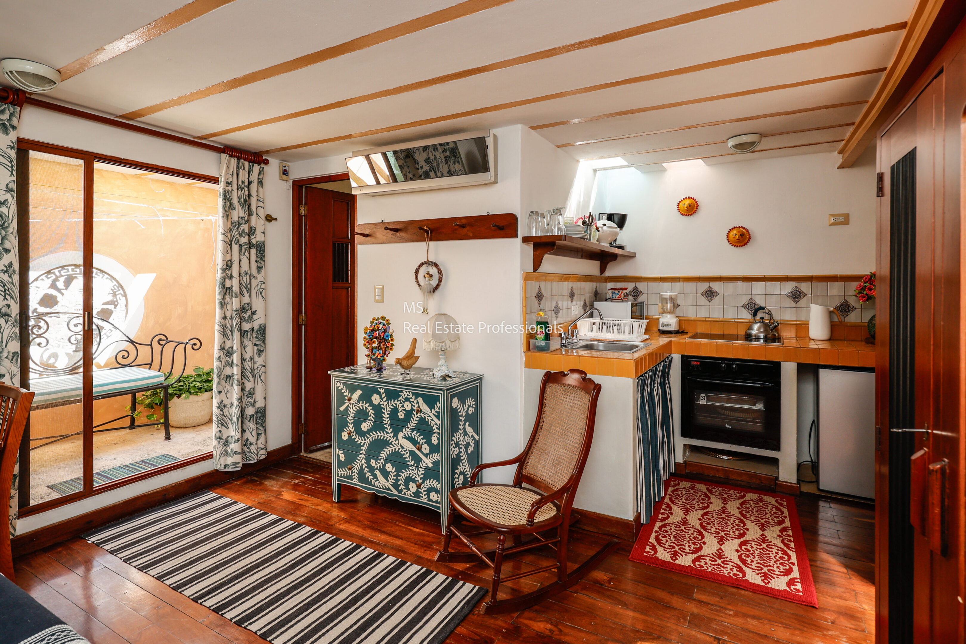 Cozy studio apartment with kitchenette and balcony.