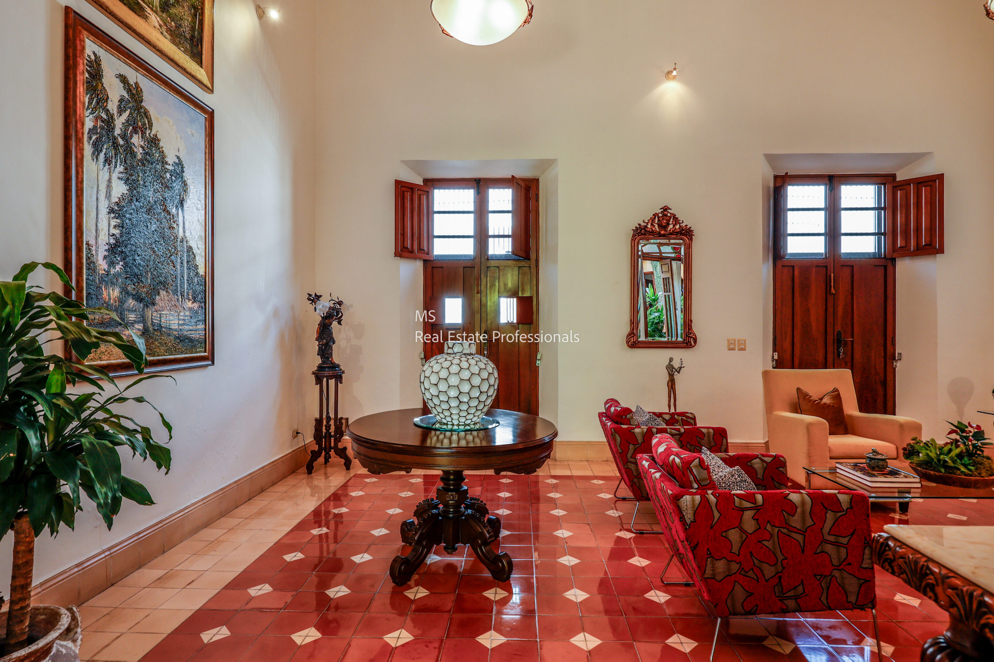 Elegant foyer with red tile floor.