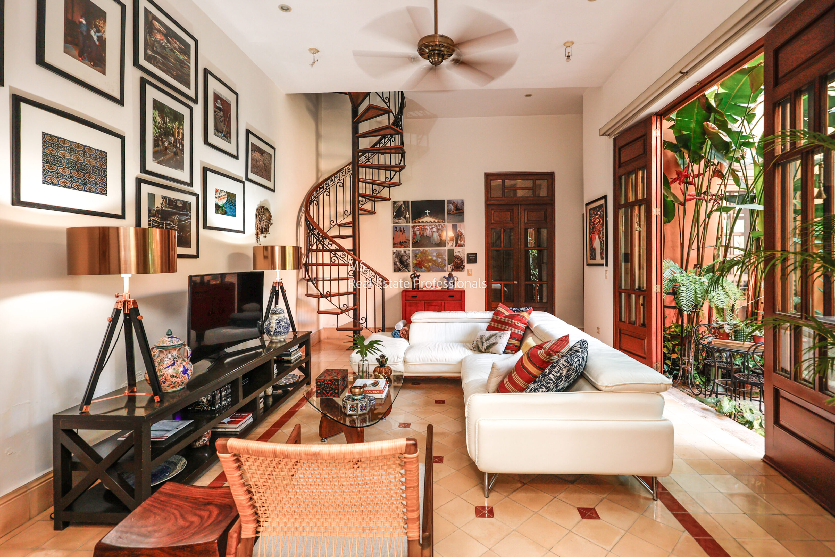 Elegant living room with spiral staircase.