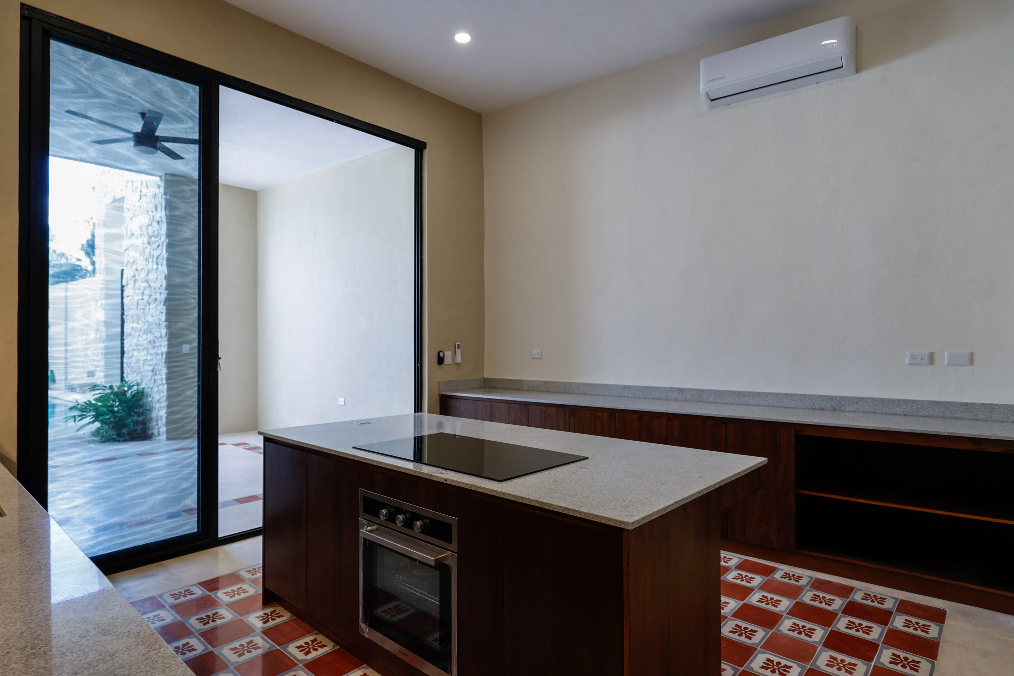 Modern kitchen with island and built-in oven.