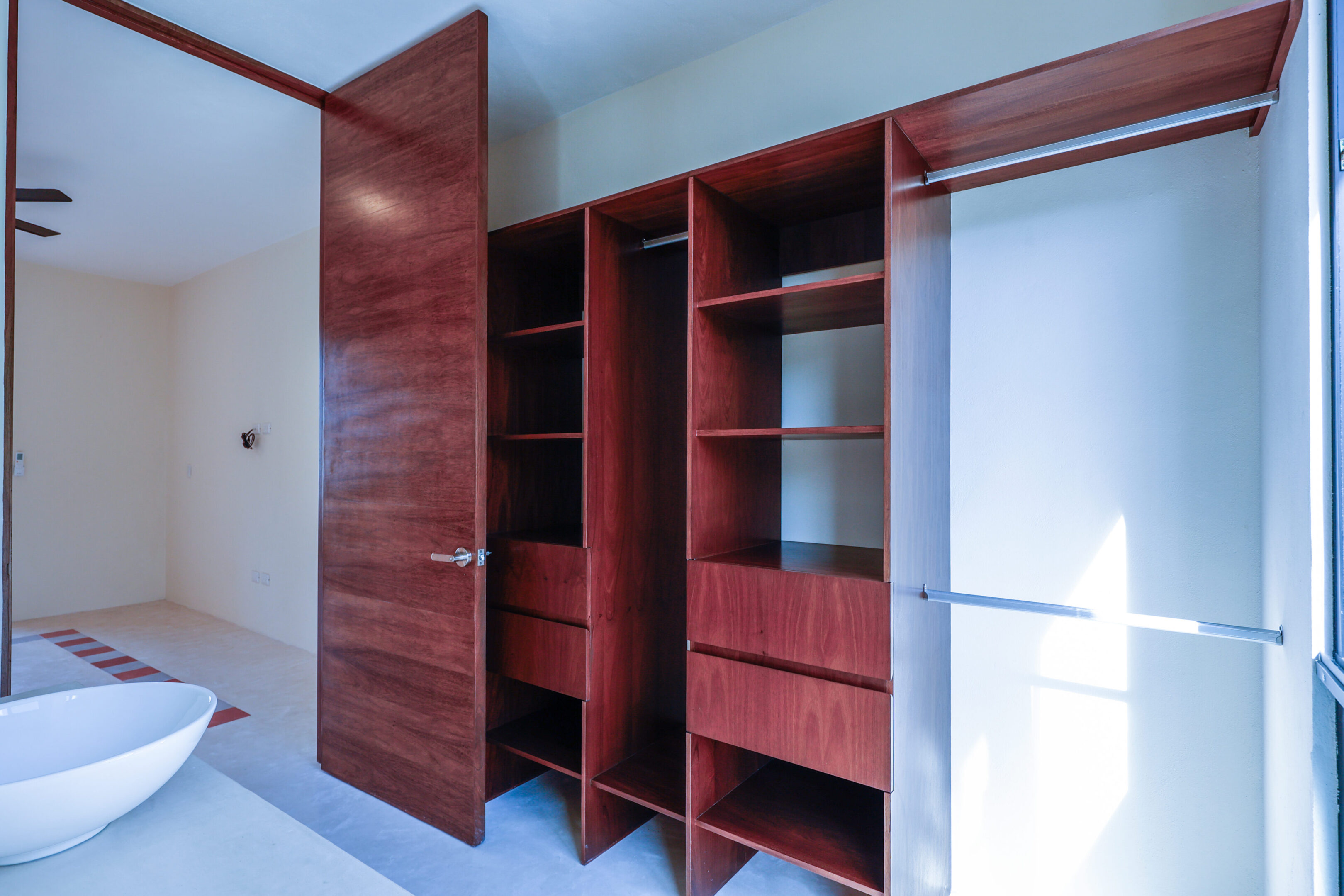 Empty wooden wardrobe with open doors and shelves.
