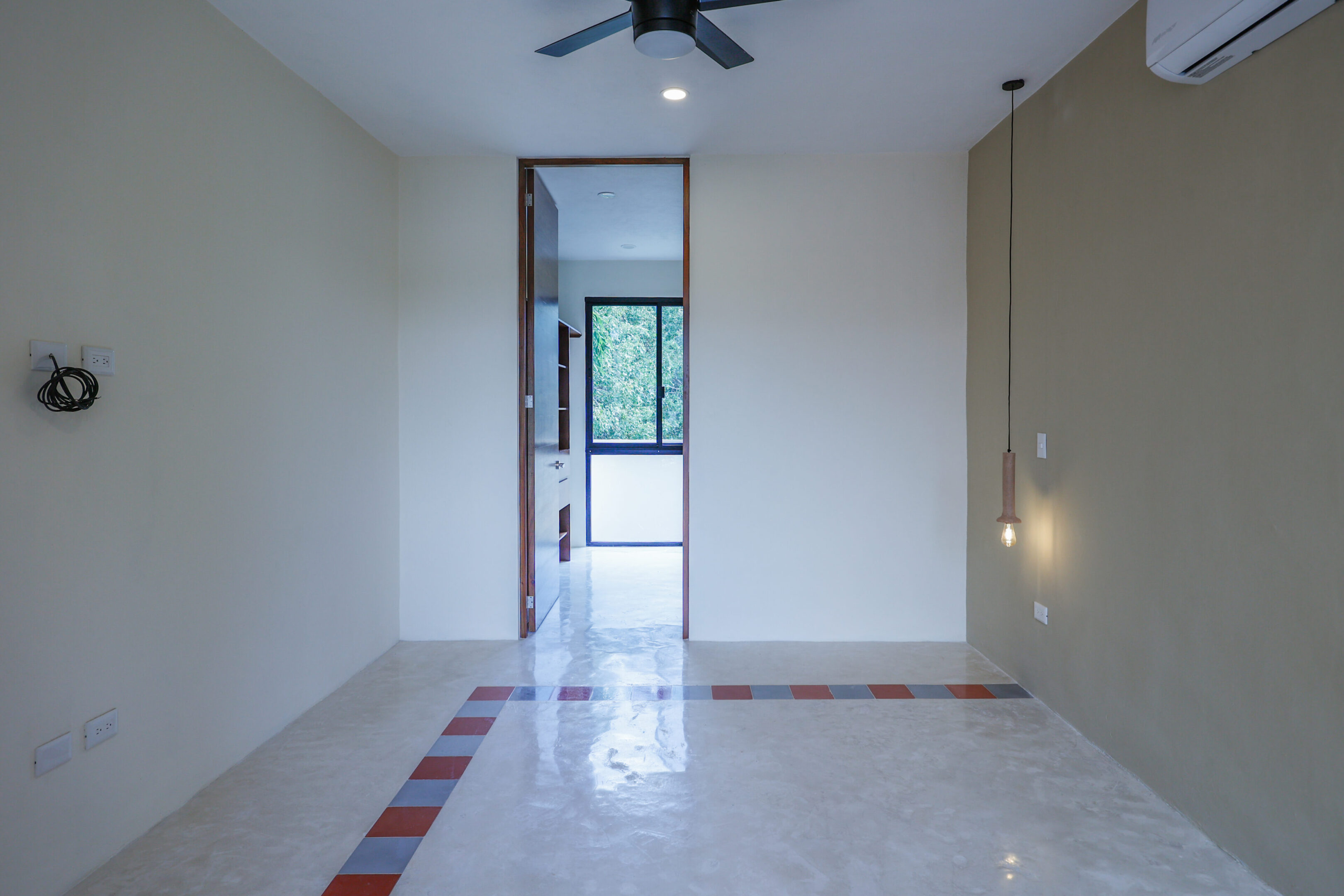 Empty room with tiled floor and ceiling fan.
