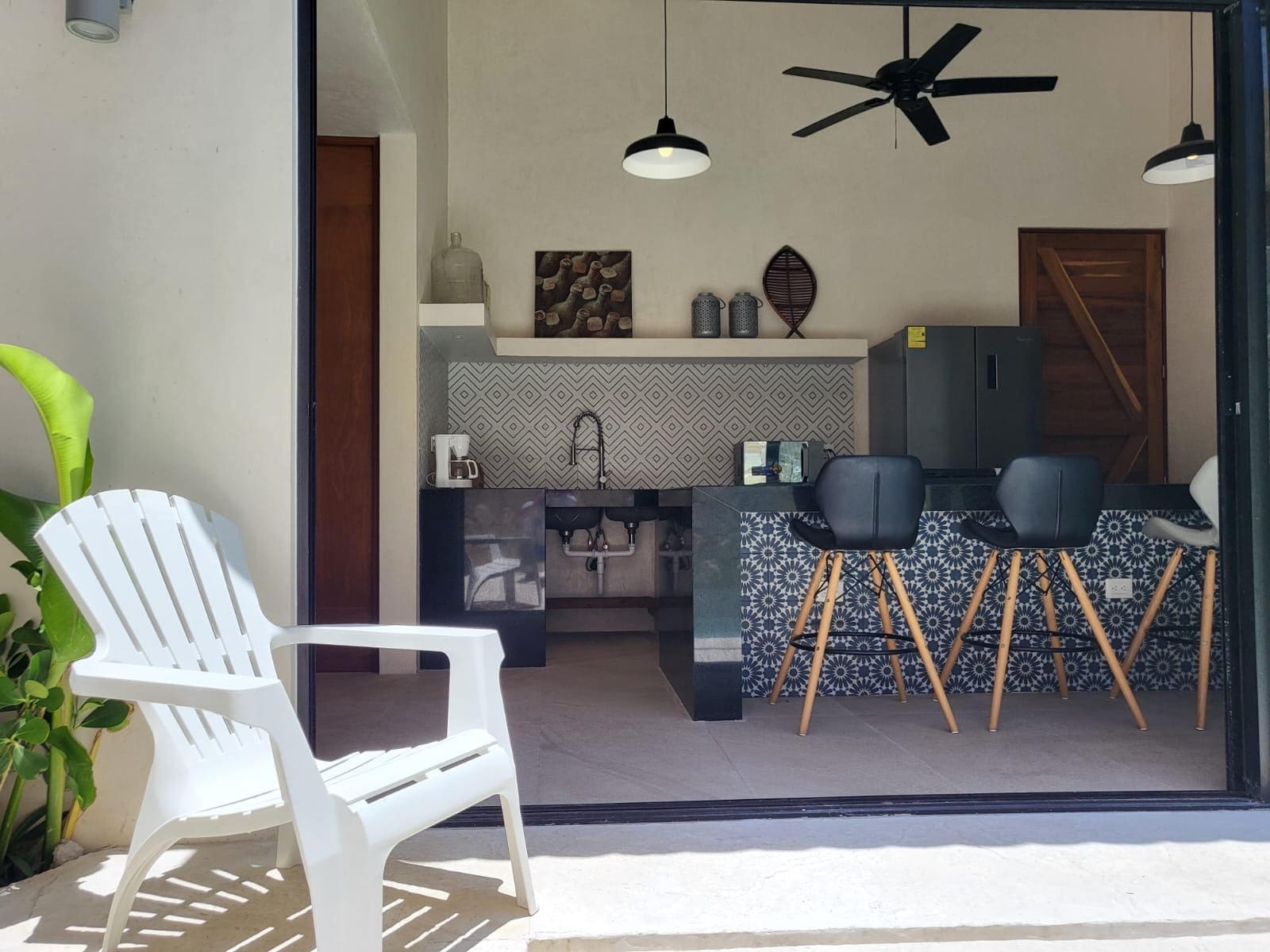 Cozy indoor dining area with black chairs and ceiling fan.