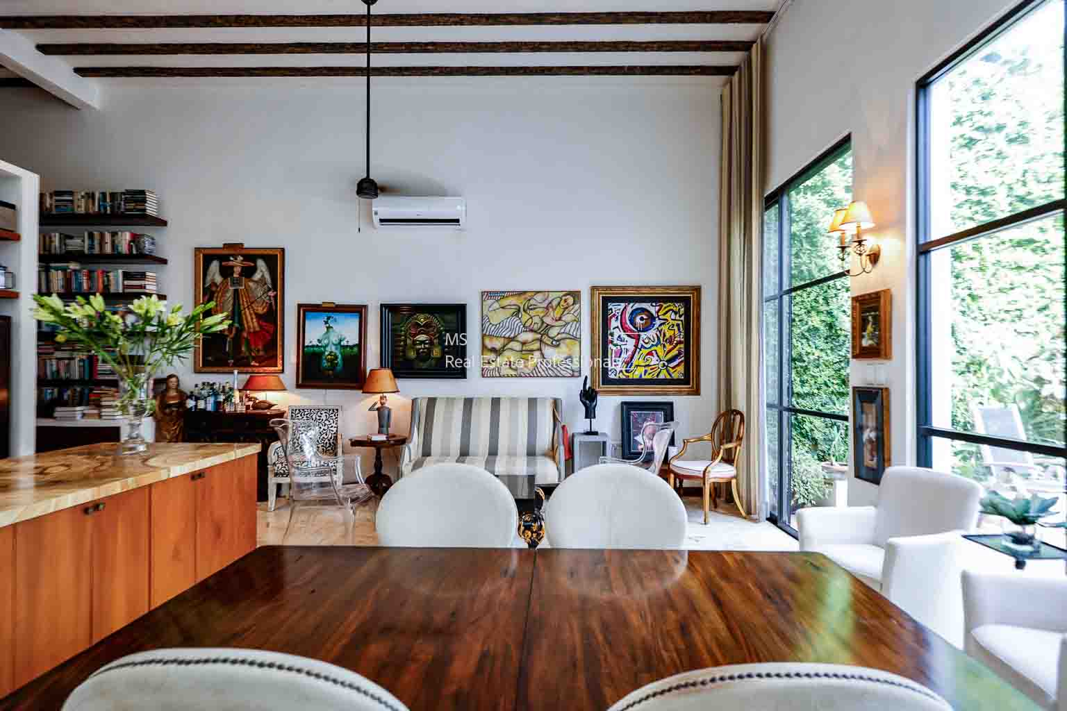 Cozy dining area with wooden table and artwork.