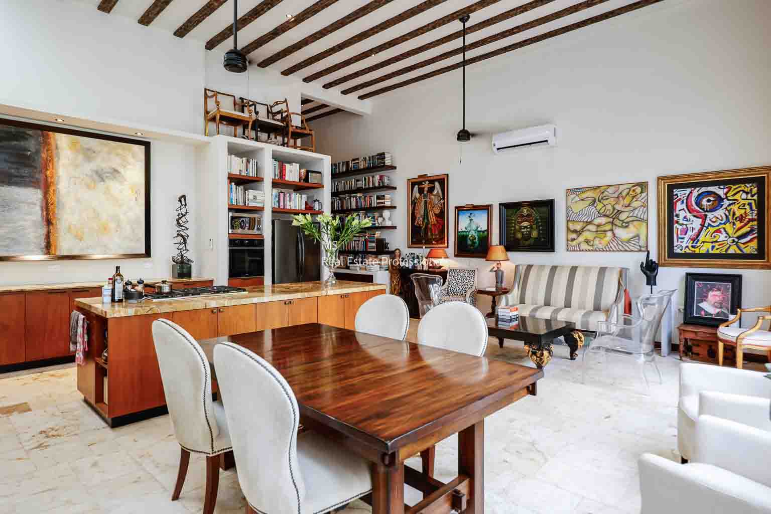 Elegant dining room with wooden table and white chairs.
