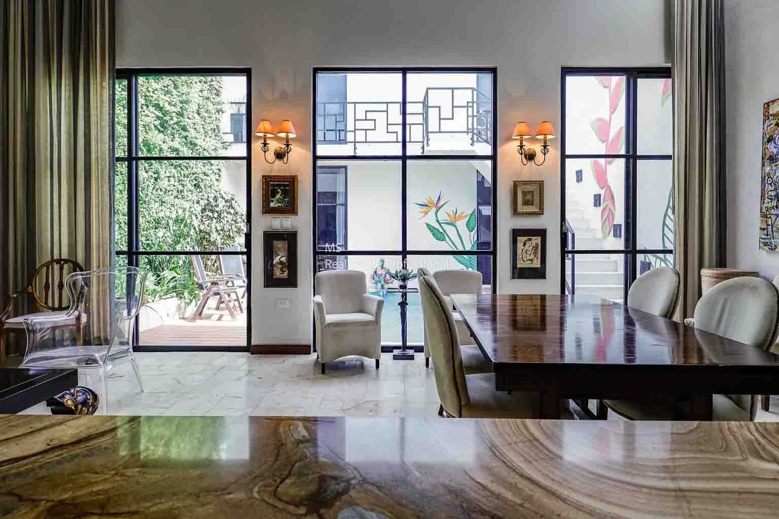 A modern dining area with large windows and elegant lighting.