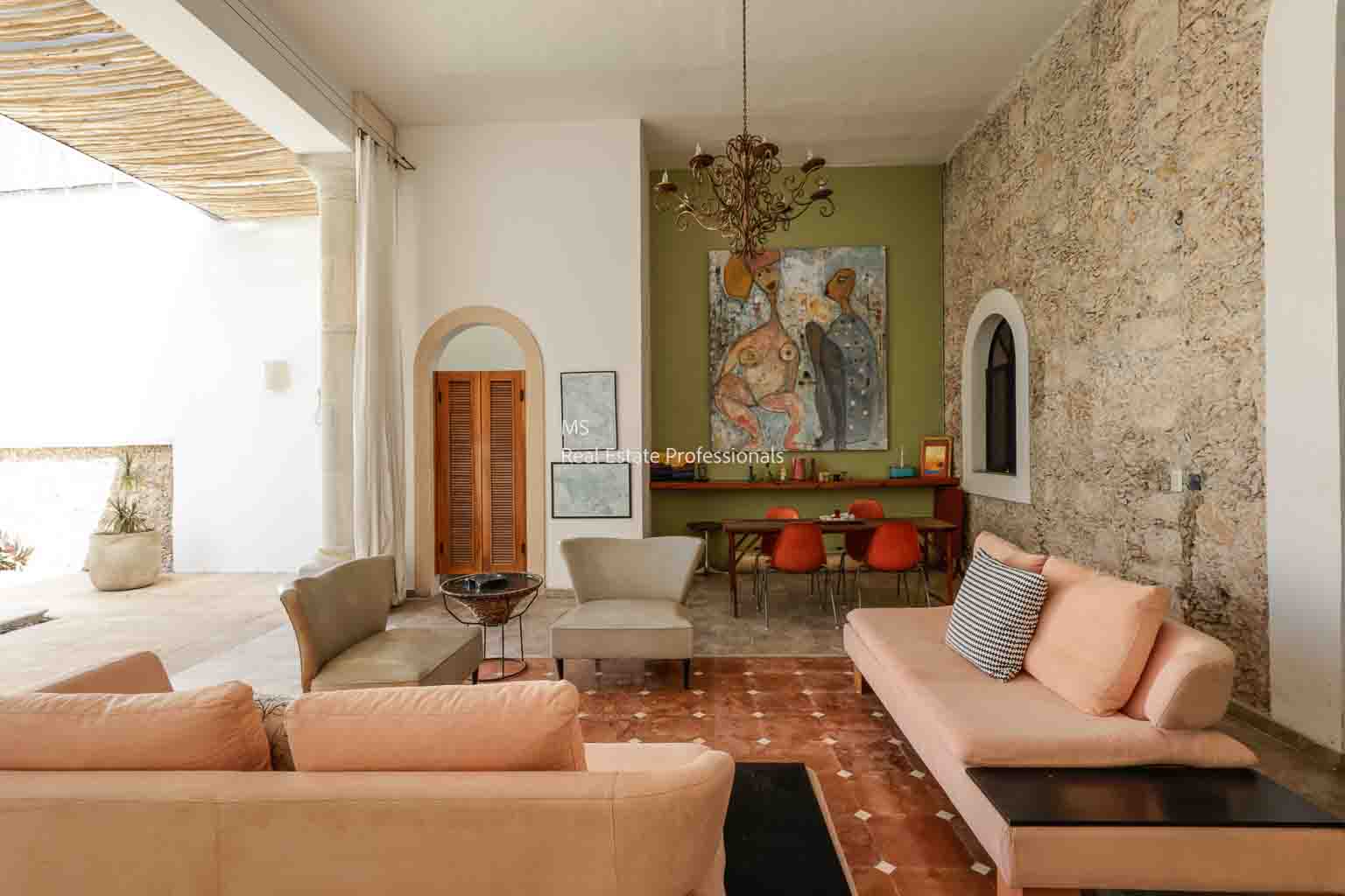 Cozy living room with warm tones and rustic stone walls.