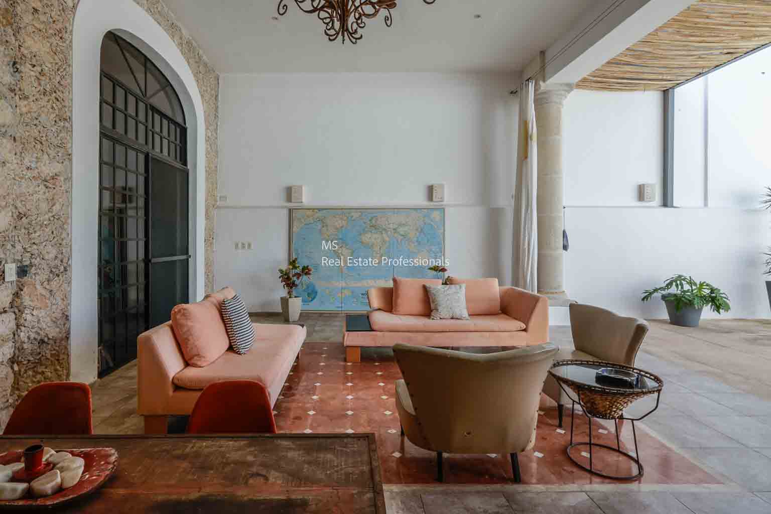 Elegant living room with peach sofas and vintage decor.