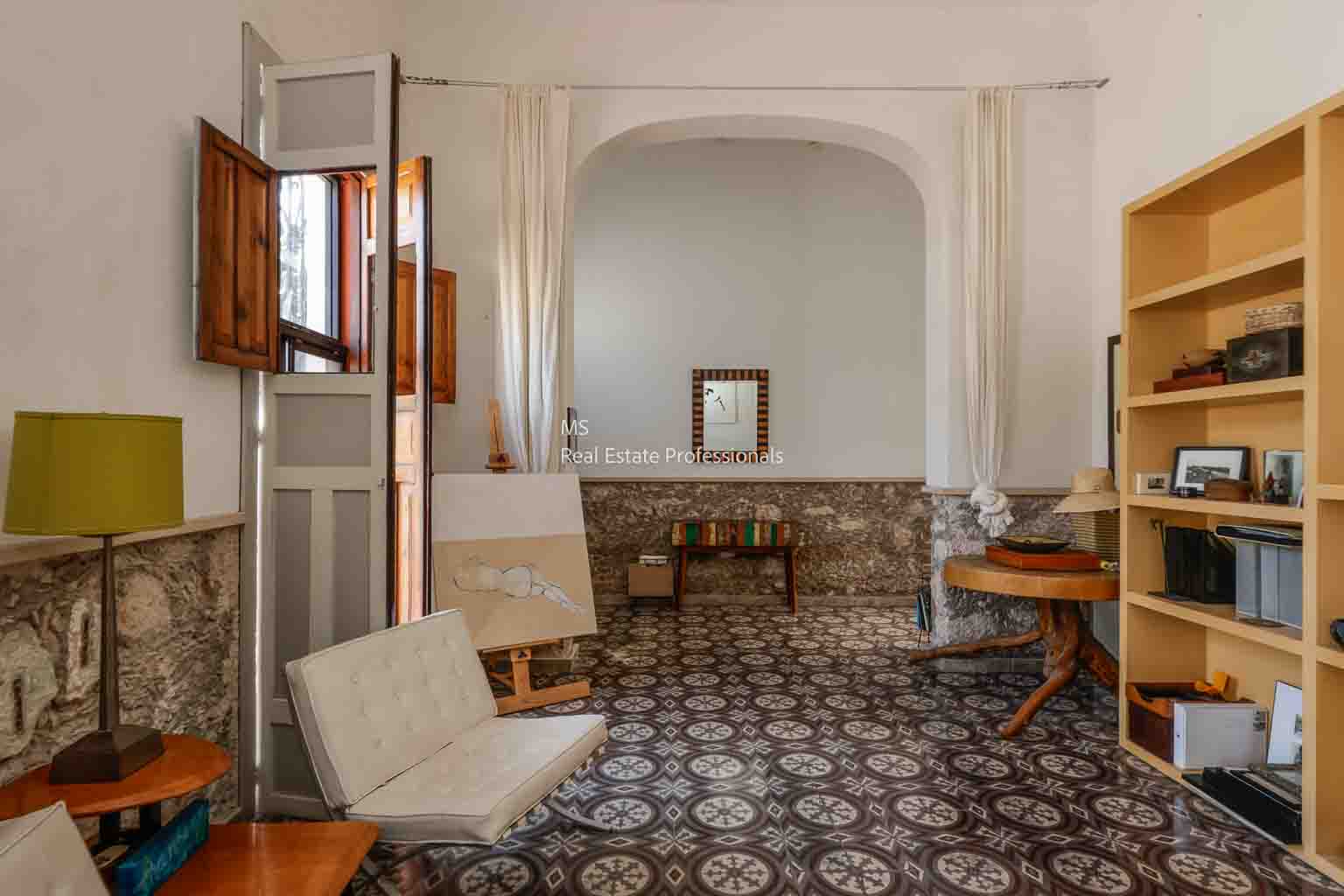 Cozy vintage room with patterned tile floor and classic furniture.