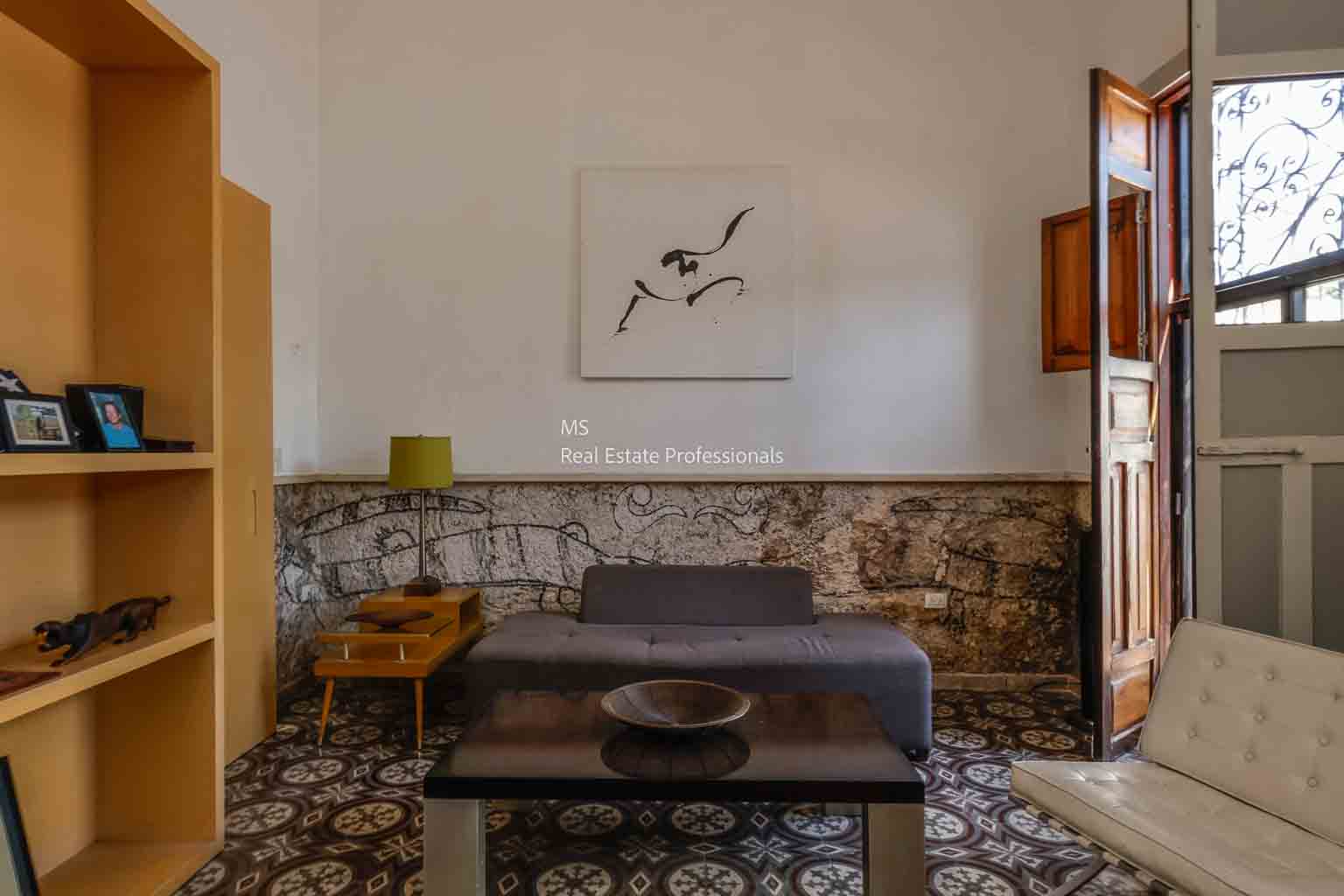 Cozy living room with rustic stone wall and minimalist decor.