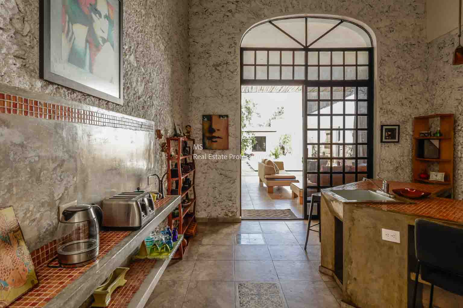 Cozy rustic interior with stone walls and vintage decor.