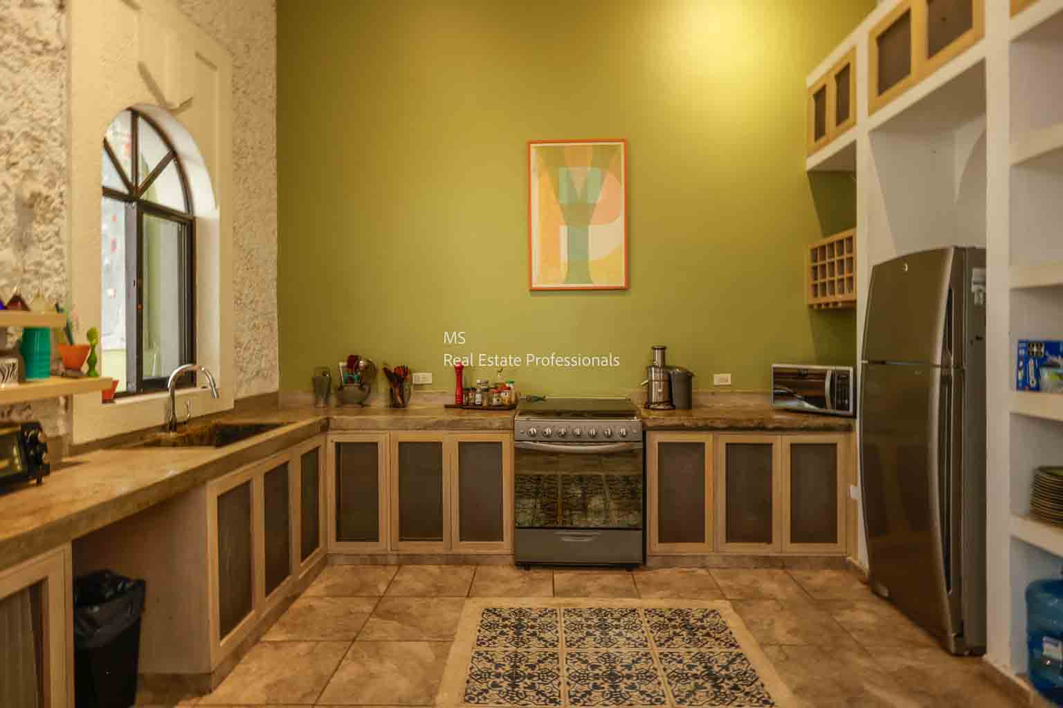 Cozy kitchen with wooden cabinets and warm lighting.