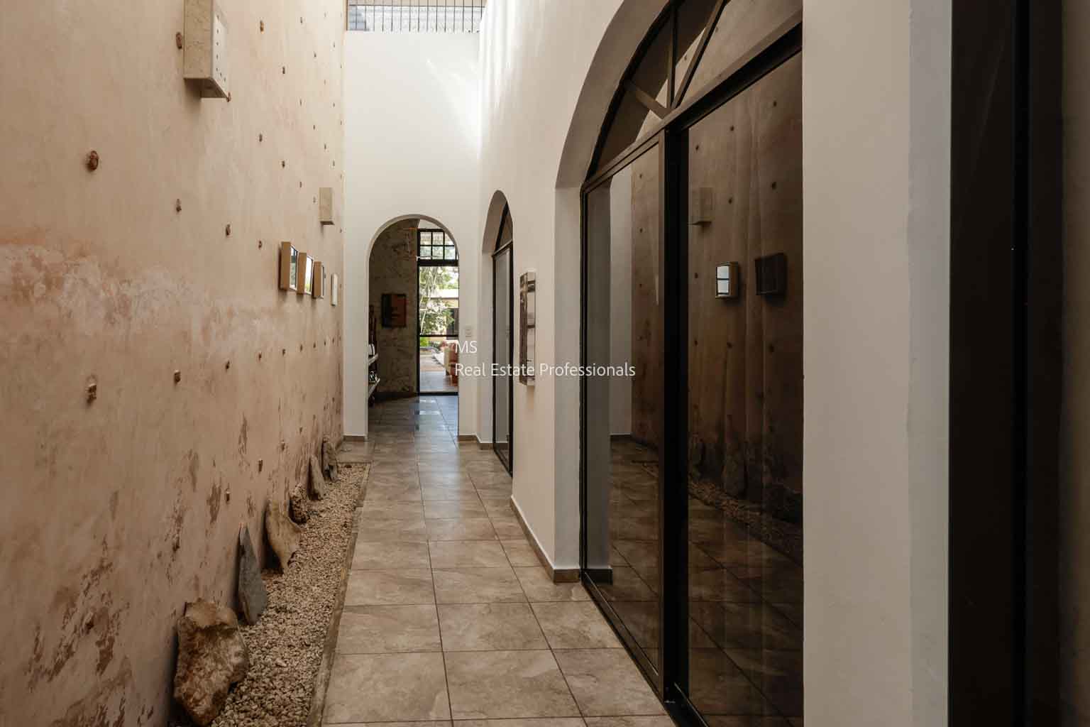 A narrow corridor with arched ceilings and worn walls.