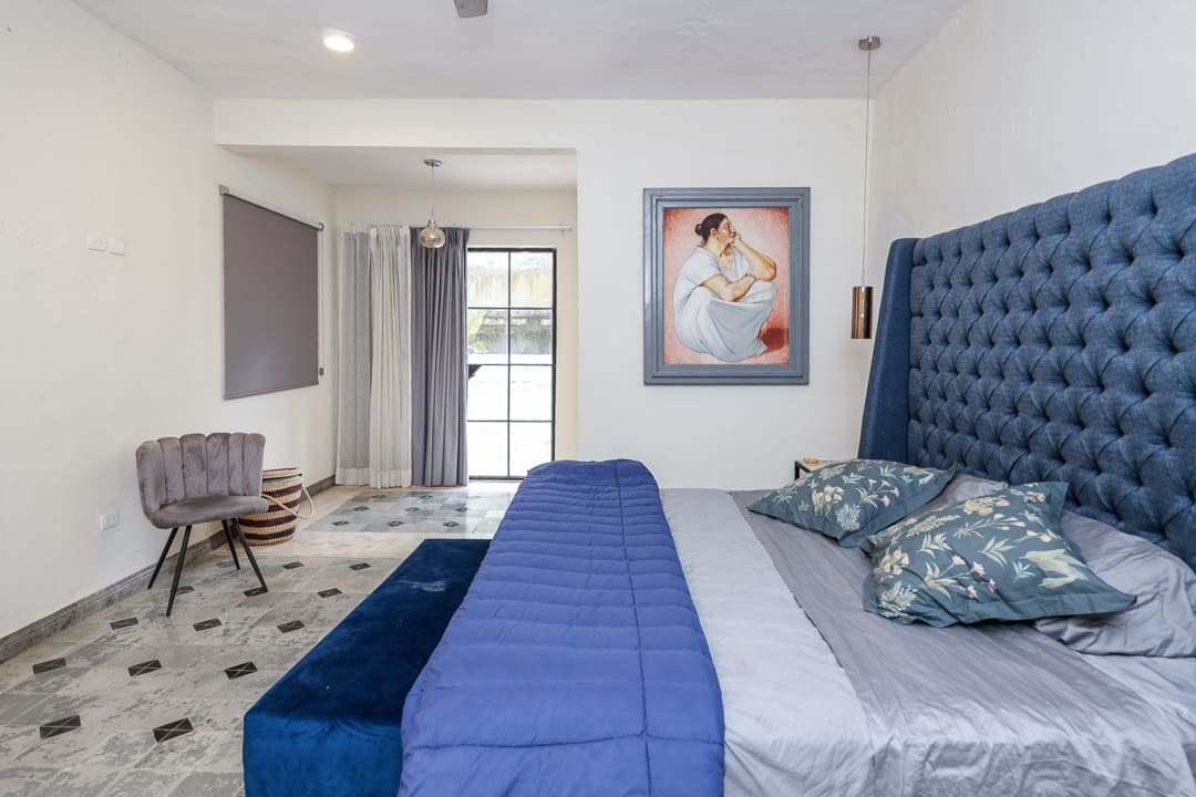 Elegant bedroom with blue accents and modern decor.