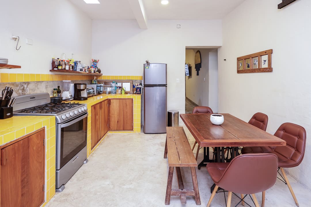 Cozy kitchen with wooden cabinetry and a dining table set.