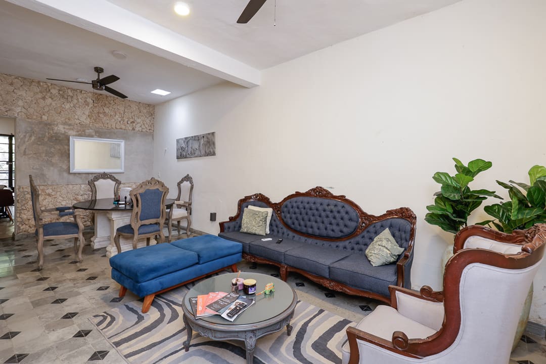 Elegant living room with classic furniture and a blue ottoman.