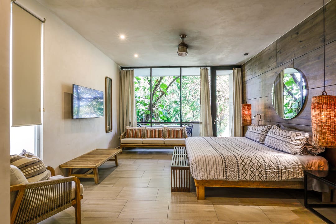 Modern bedroom with large windows and natural light.