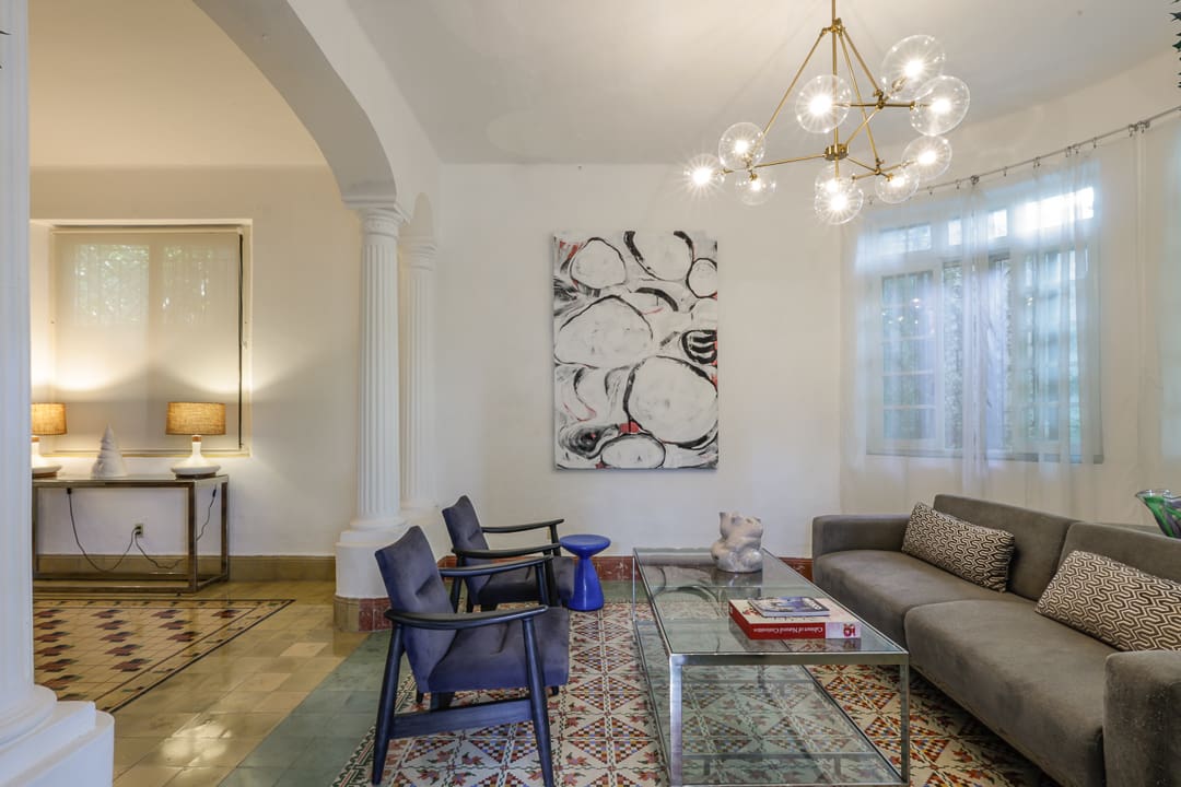 Elegant living room with modern furniture and artistic decor.