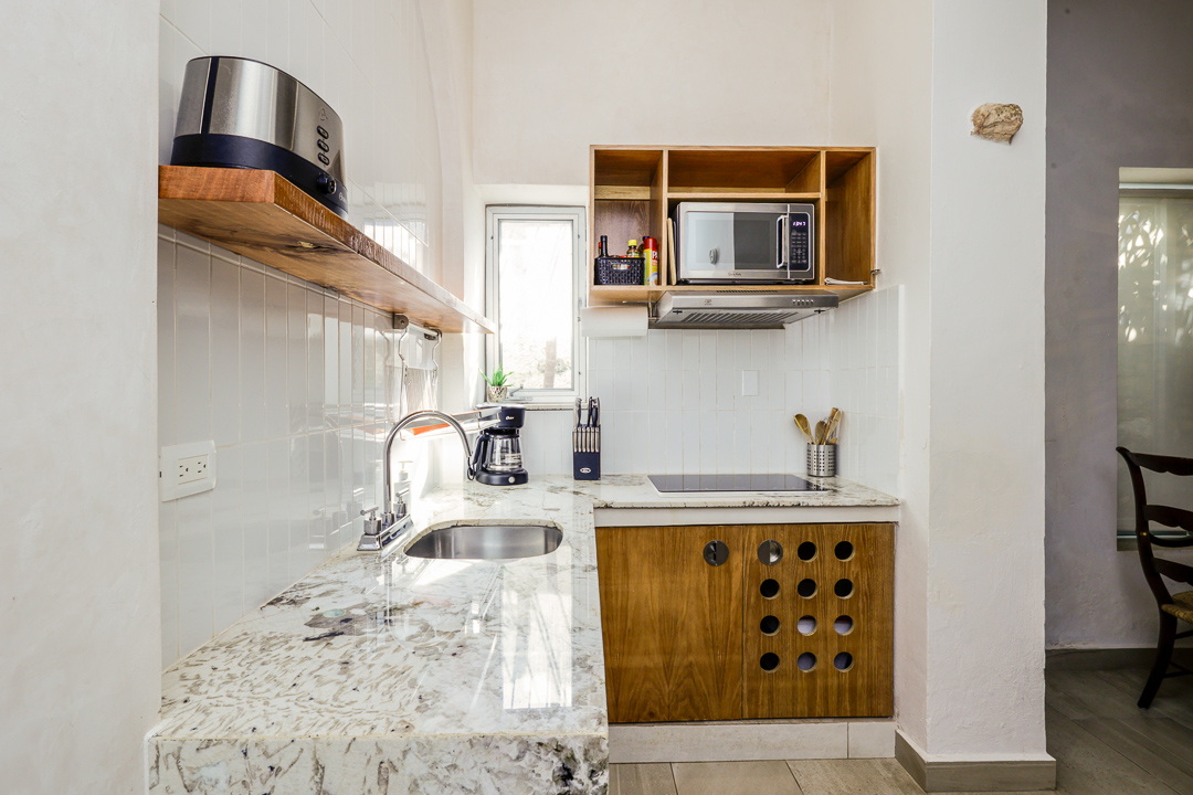 Modern kitchen with granite countertops and wooden cabinets.