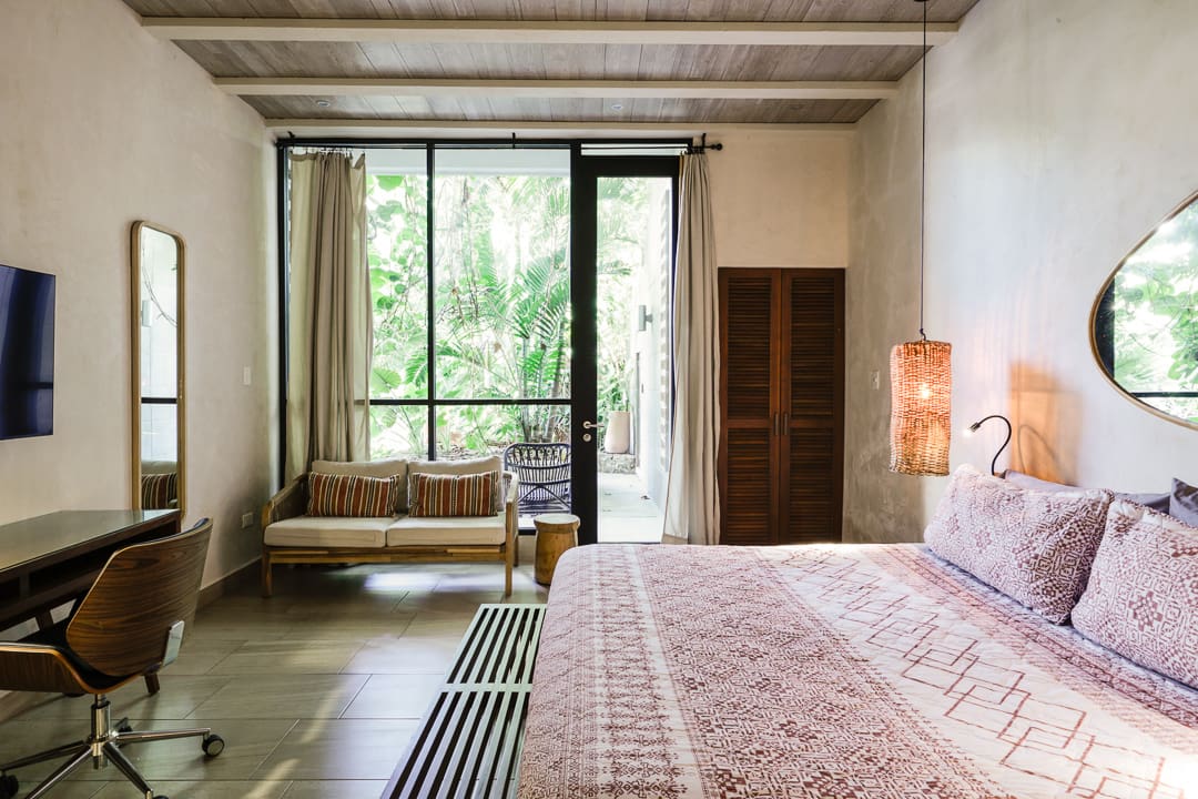 Cozy bedroom with natural light and rustic decor.