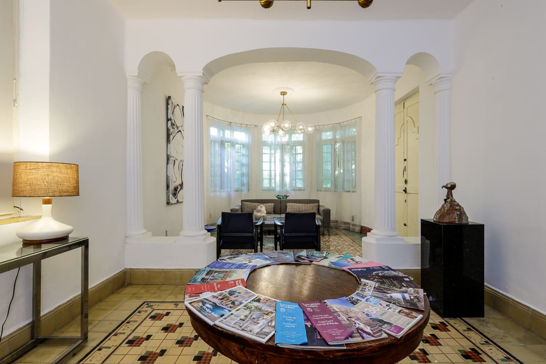 Elegant dining room with a round table and colorful magazines.