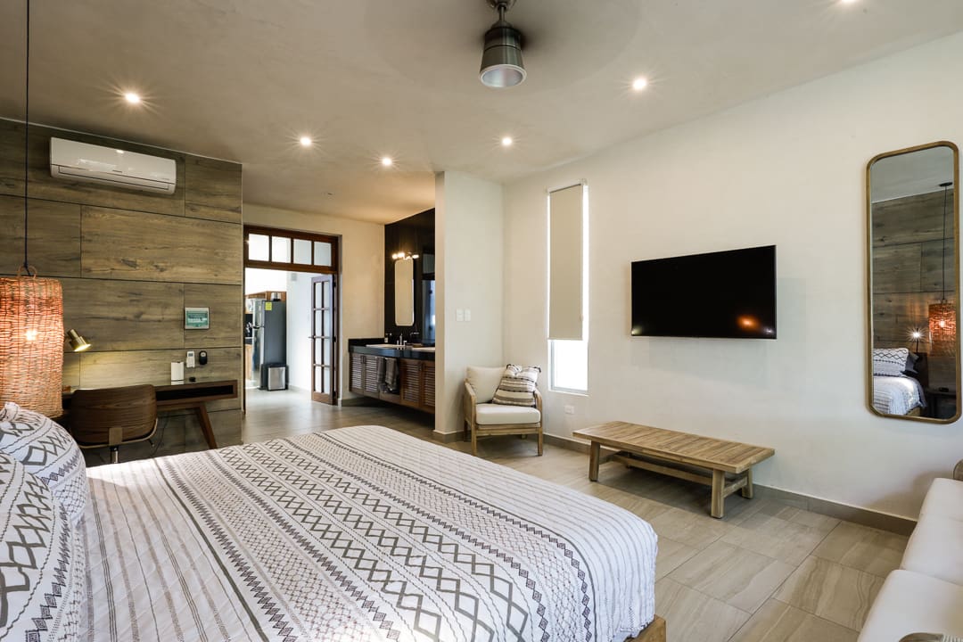 Modern bedroom with minimalist decor and neutral tones.