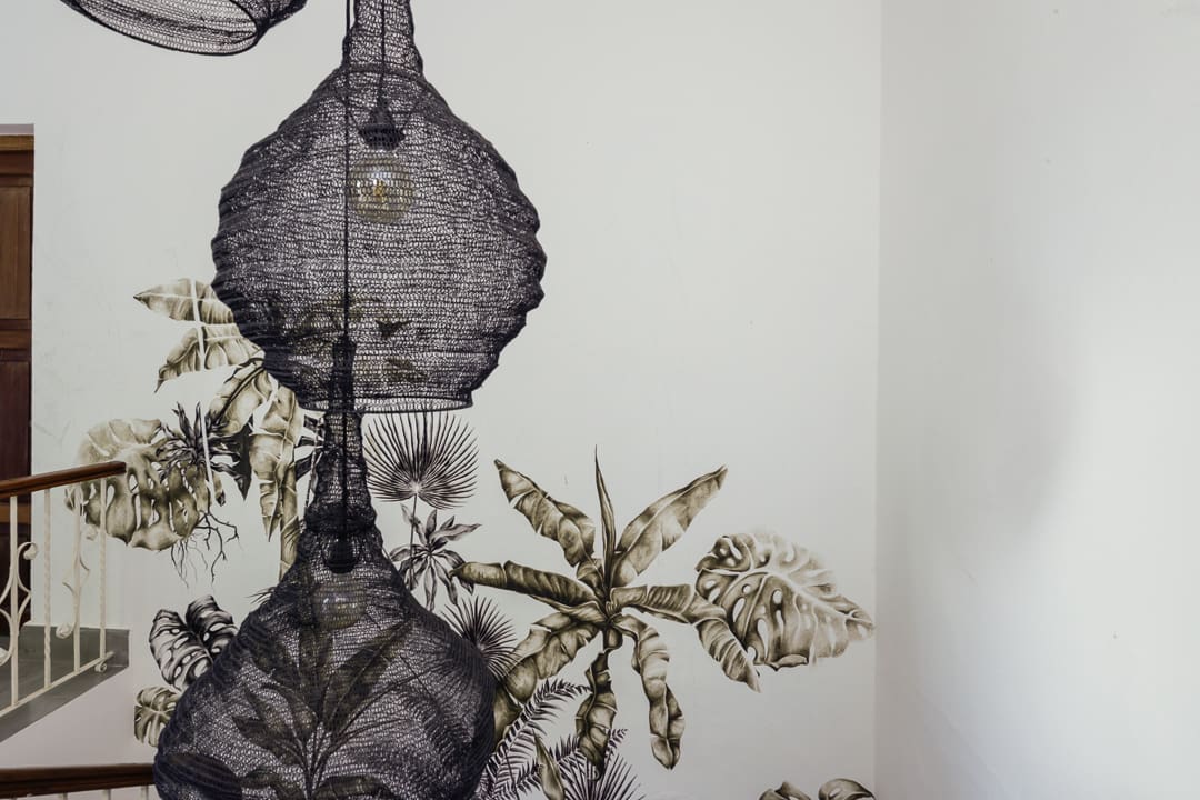 Artistic black ink patterns on textured paper.