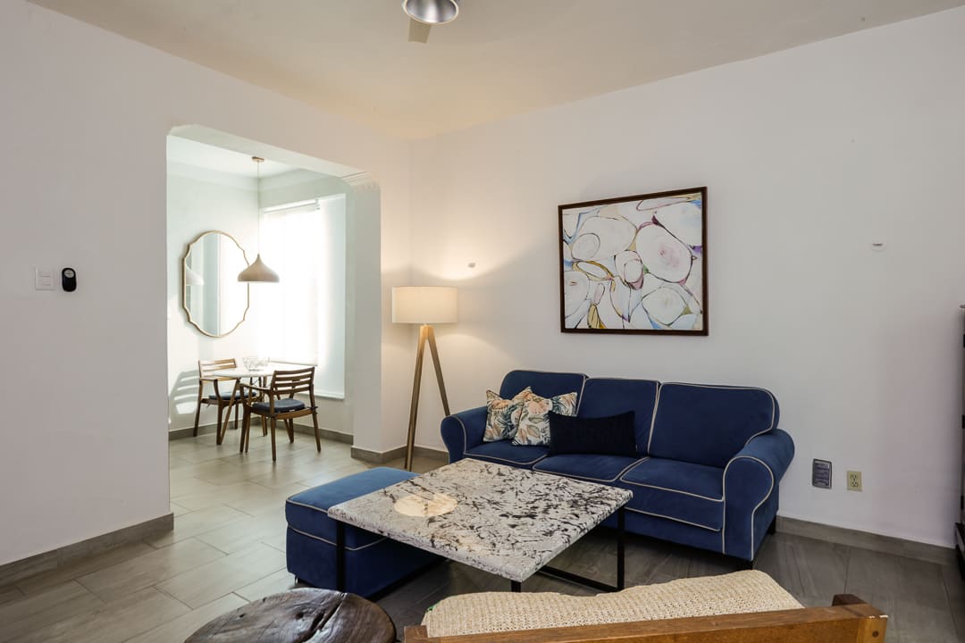 Cozy living room with a navy sofa and modern decor.