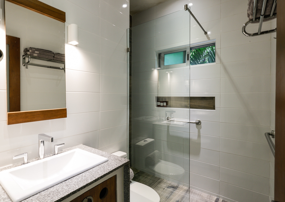 Modern bathroom with glass shower and sleek fixtures.