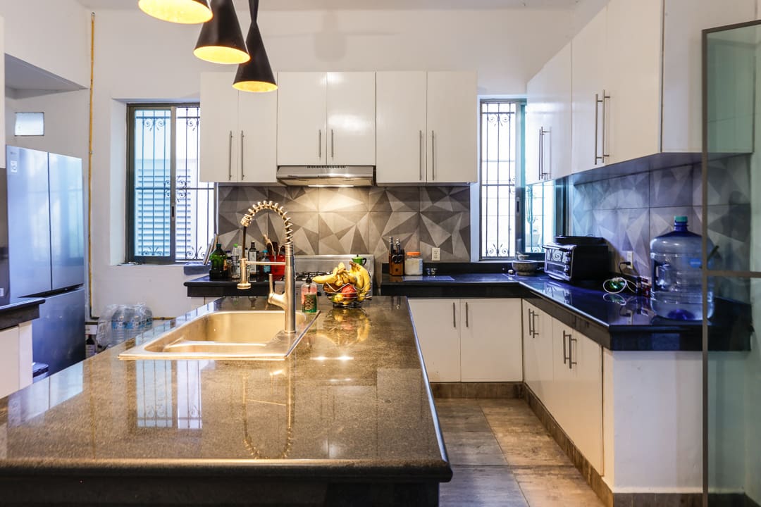Modern kitchen with black and white cabinets and a spacious island.