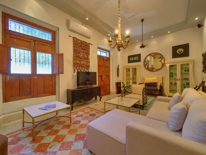 Cozy living room with vintage decor and warm lighting.