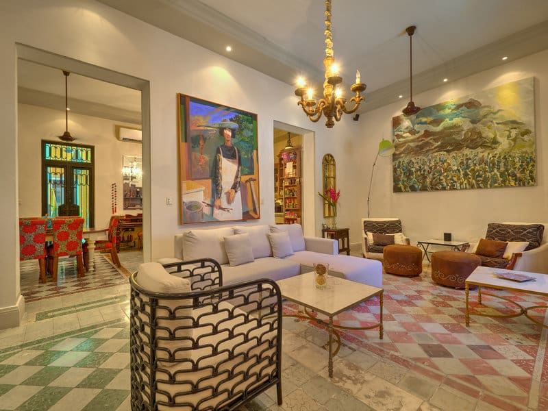 Elegant living room with modern art and cozy seating.