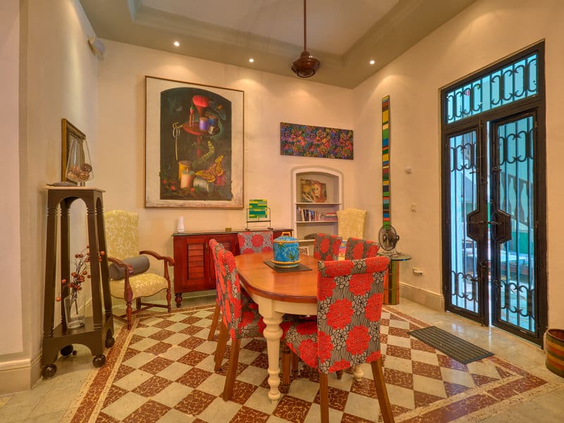 Cozy vintage dining room with eclectic chairs and warm lighting.