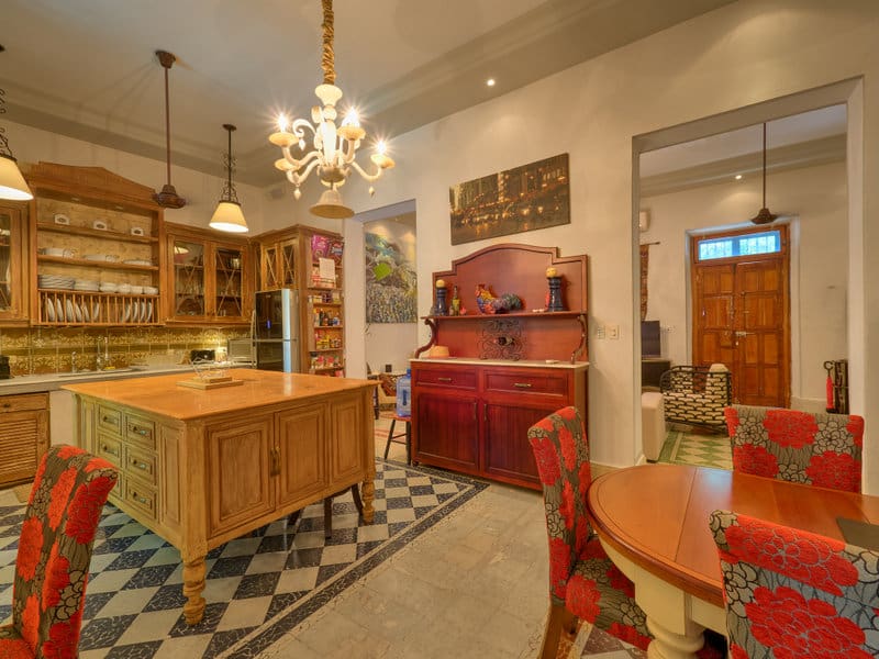 Charming vintage kitchen with wooden furniture and checkered floor.