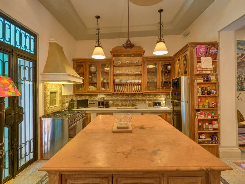 Cozy rustic kitchen with wooden cabinets and a large island.