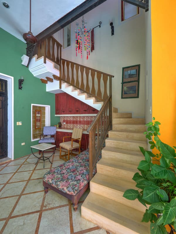 Cozy indoor staircase with vibrant walls and comfortable seating area.
