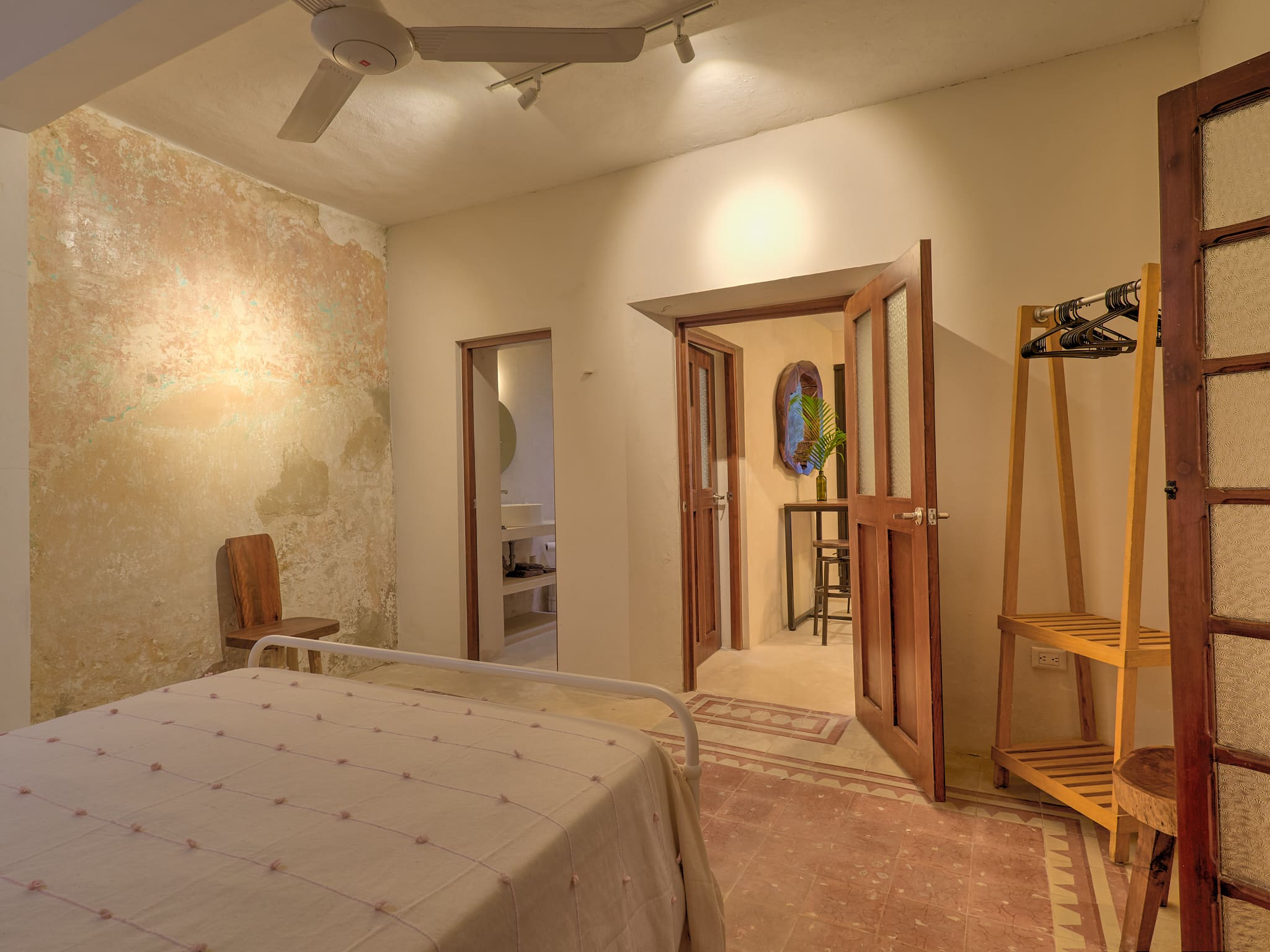 Cozy bedroom with soft lighting and wooden furniture.