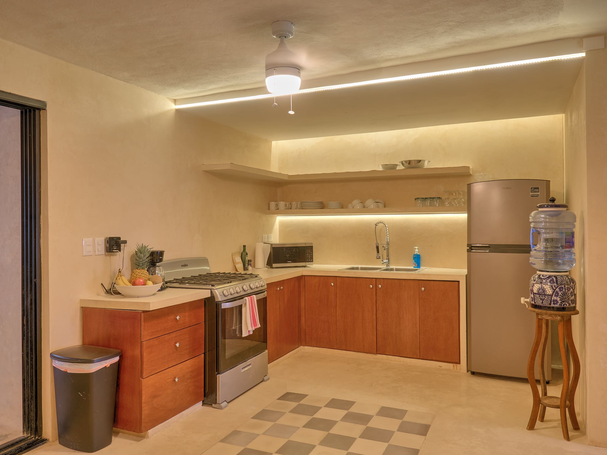 Cozy kitchen corner with warm lighting and modern appliances.