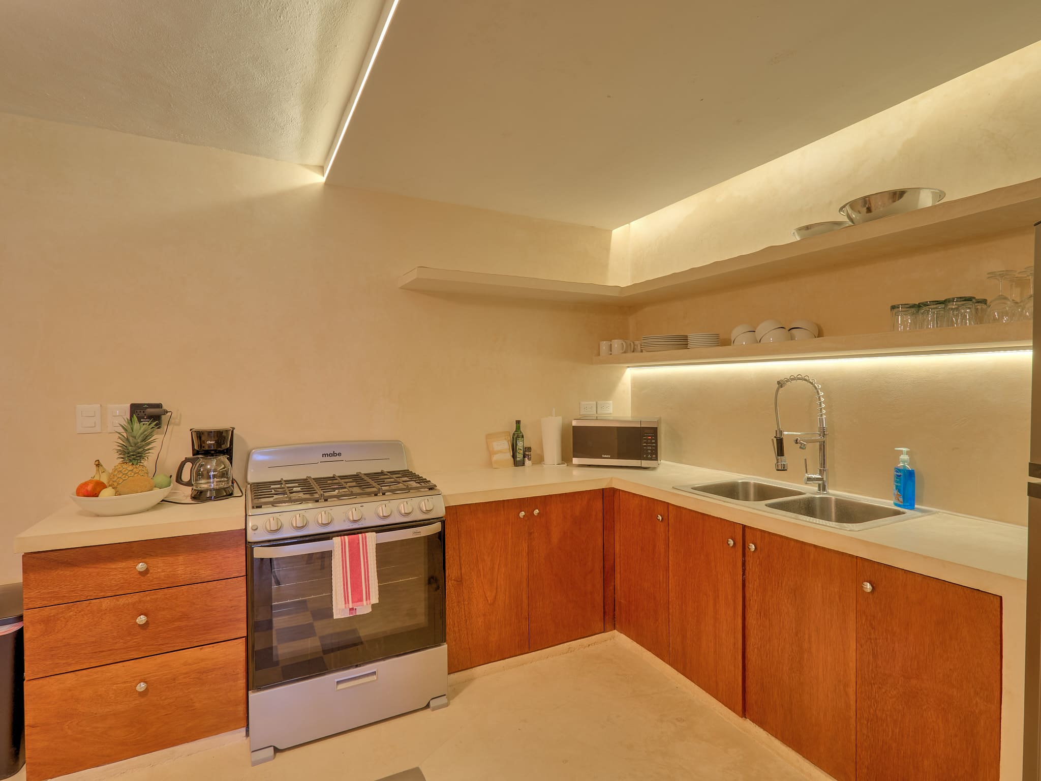 Modern kitchen with wooden cabinets and stainless steel appliances.