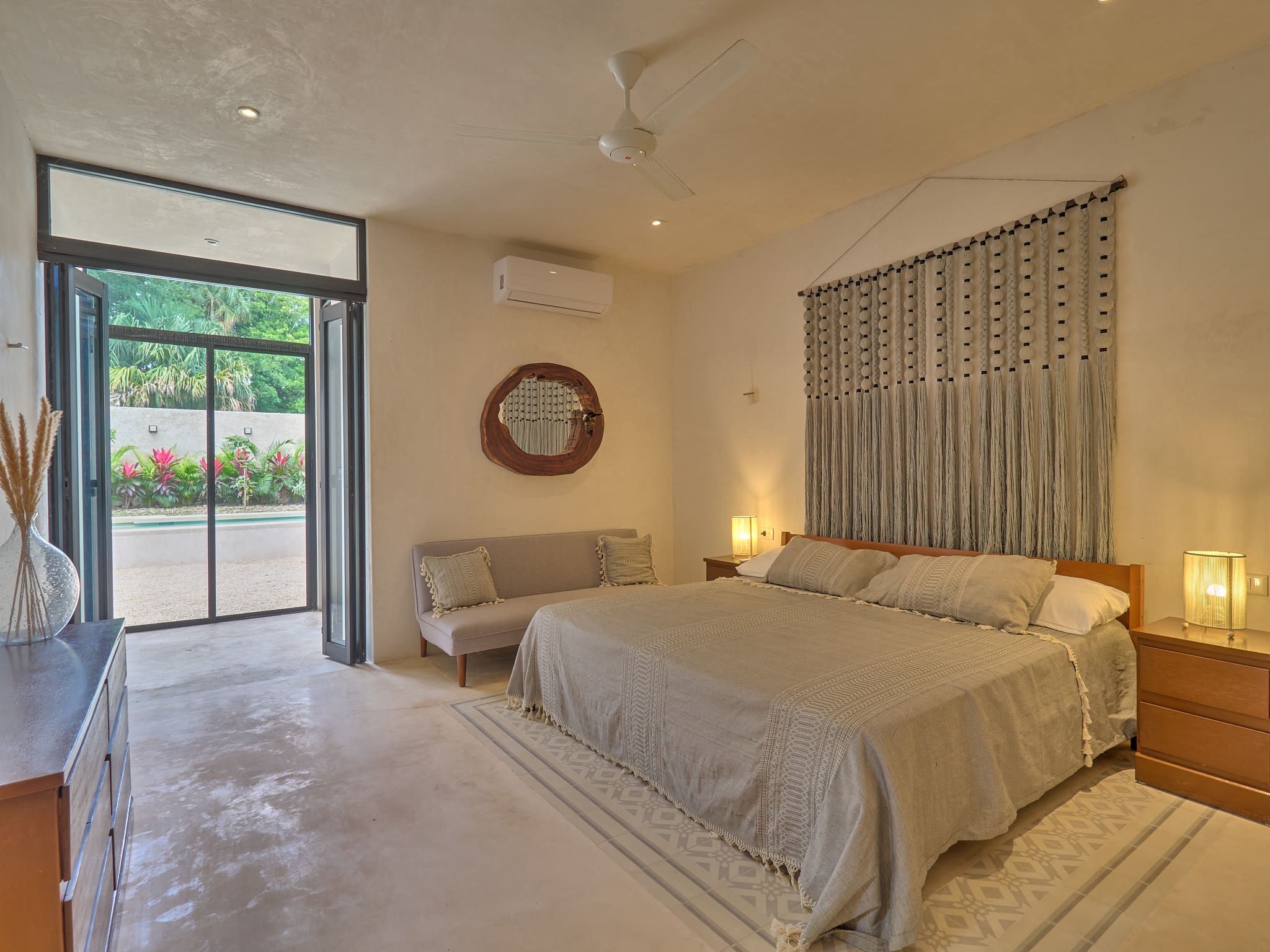 Cozy bedroom with double bed and single bed near a glass door.