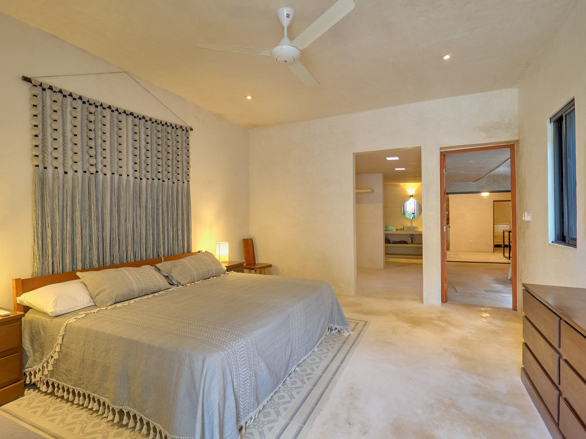 Cozy bedroom with neutral tones and soft lighting.