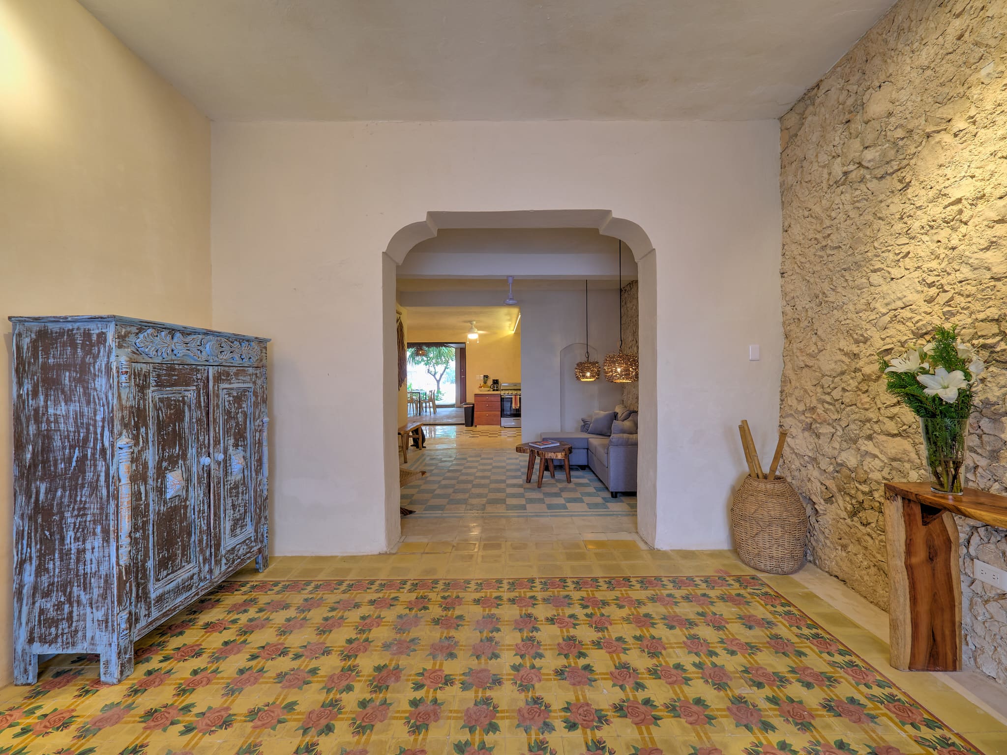 Cozy interior with patterned tile floor and stone wall.