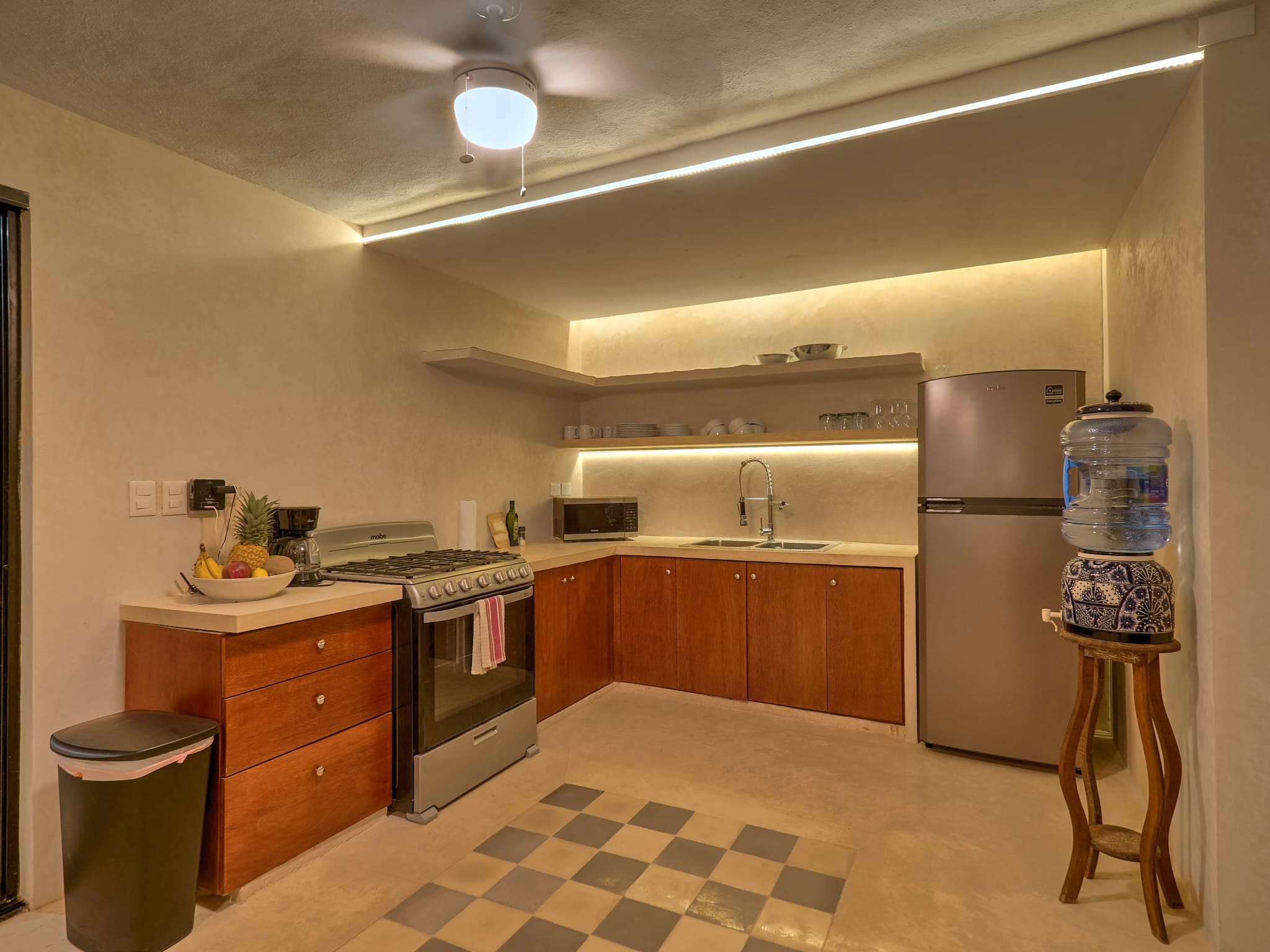 Cozy kitchen with wooden cabinets and warm lighting.