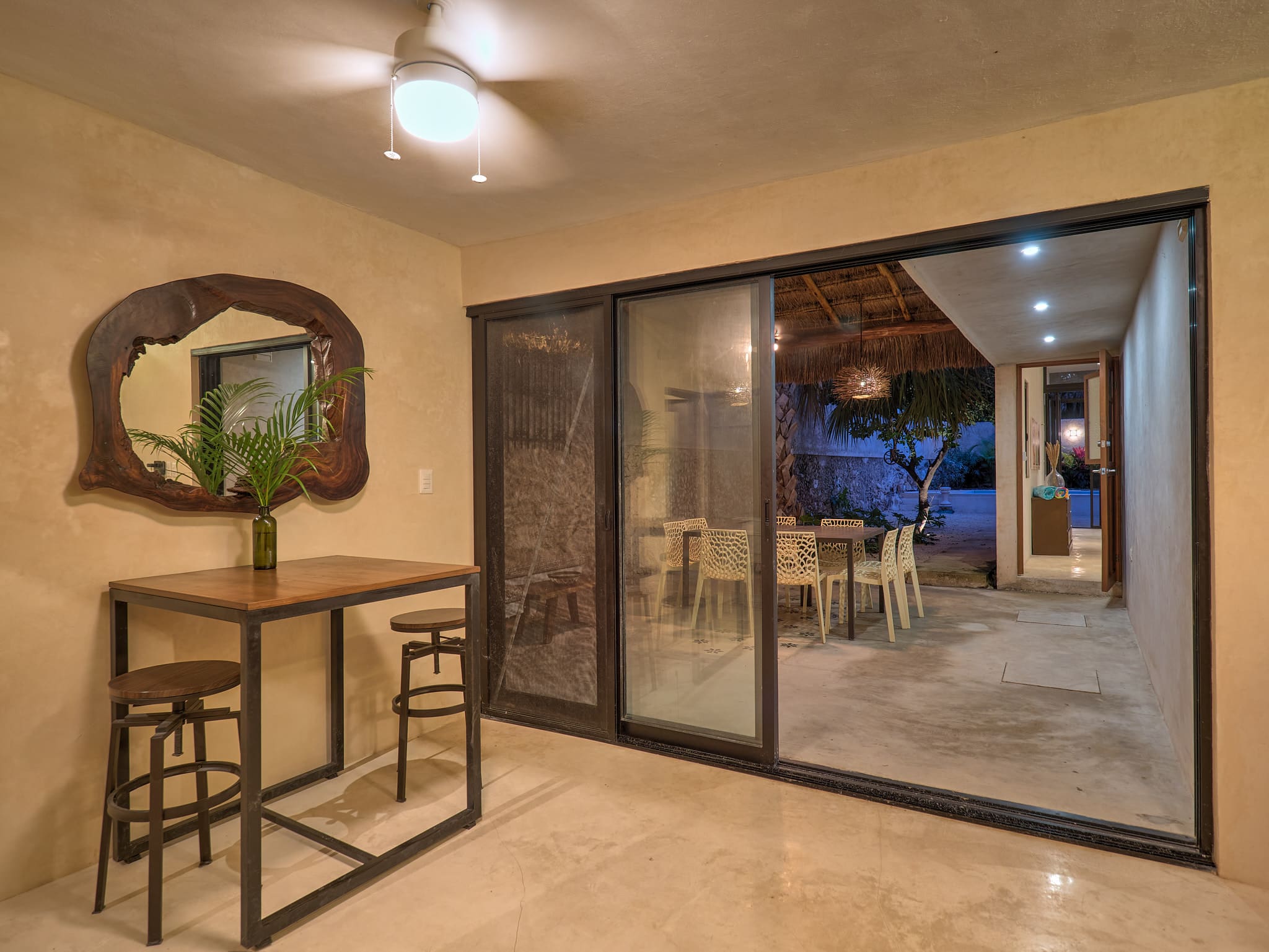 Cozy indoor seating area with table and chairs near glass sliding doors.