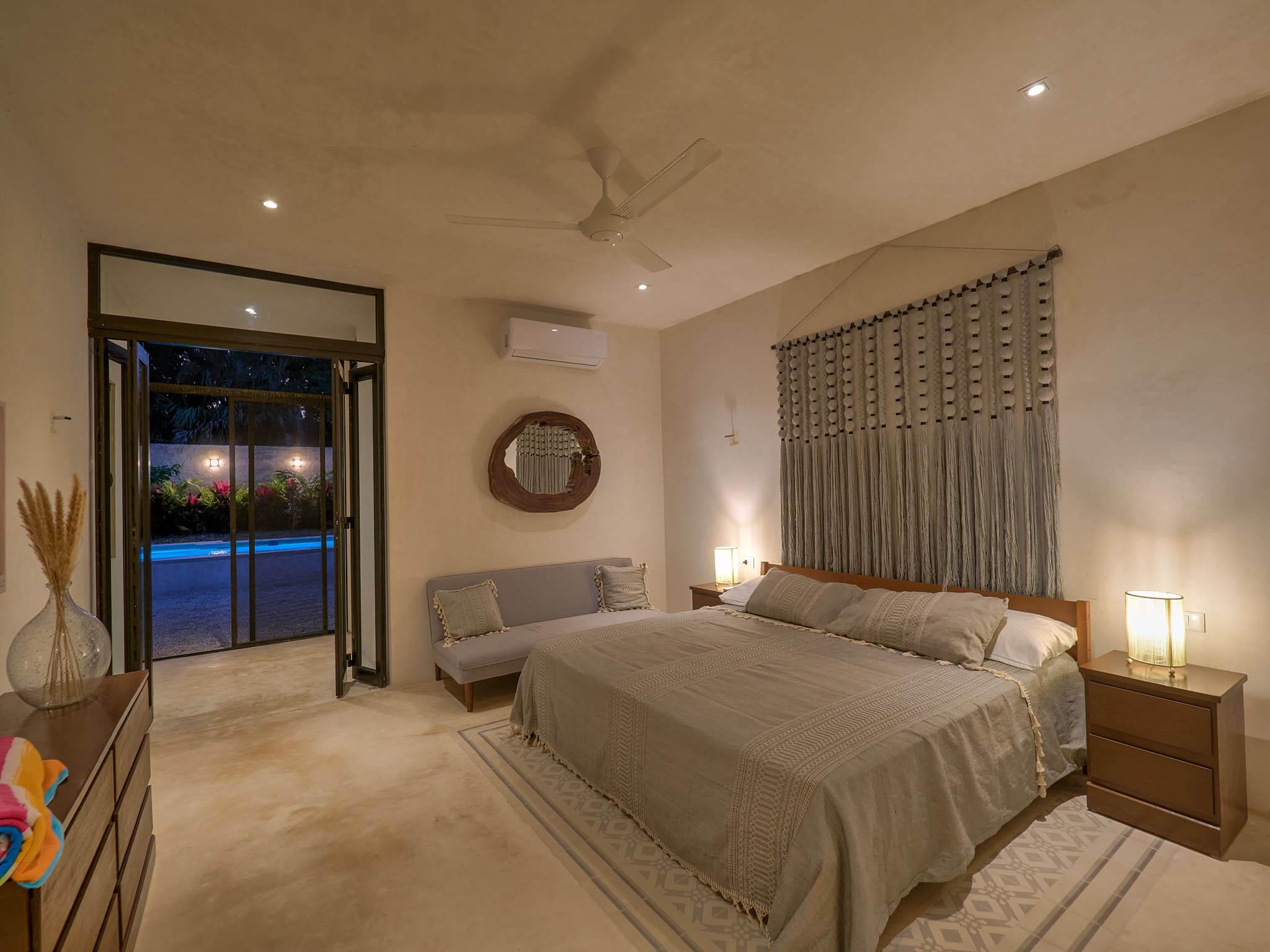 Cozy bedroom with neutral tones and soft lighting.
